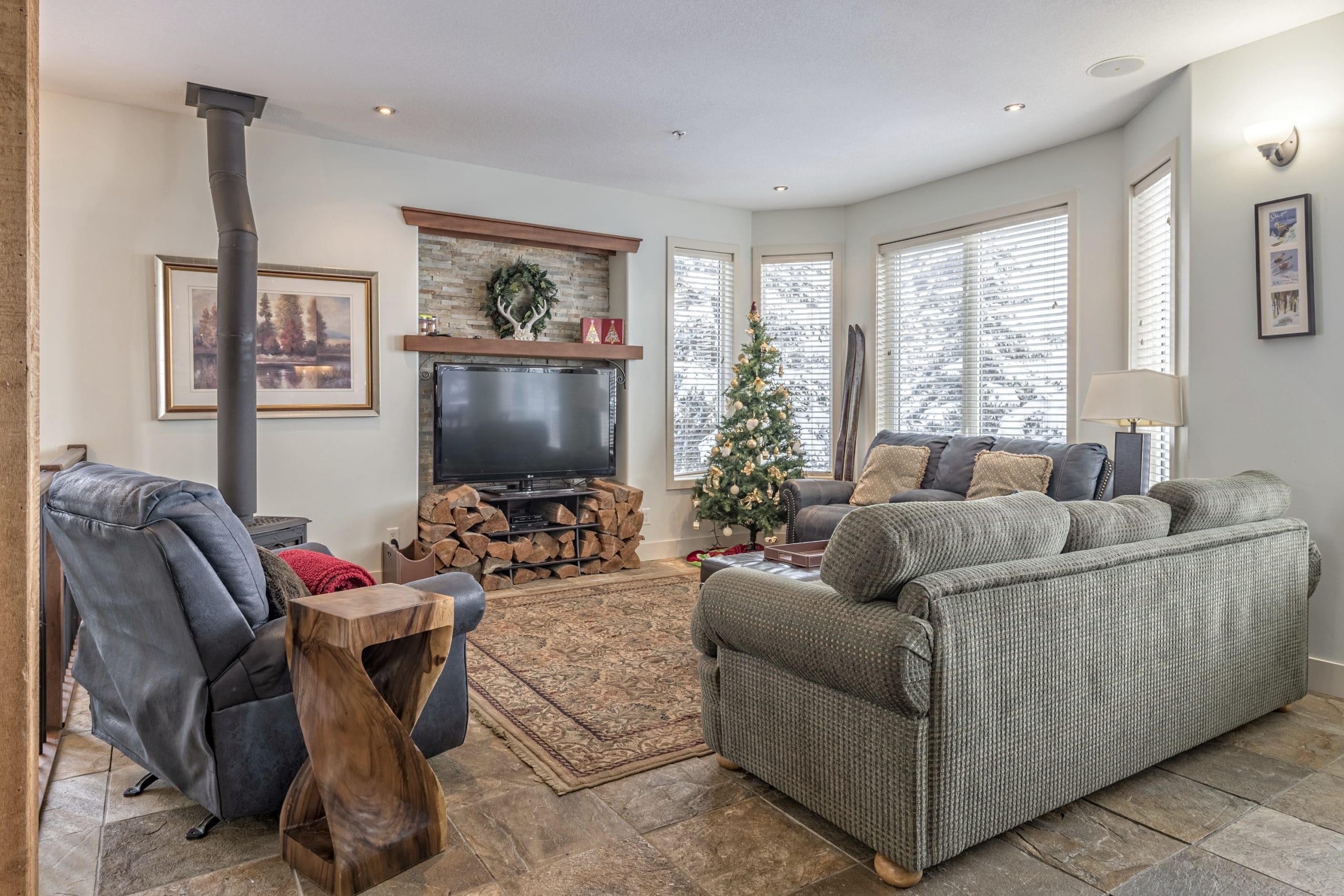 Upper living room with gas fireplace. Two levels of living for families and friends to spread out. Great views of the Monashee Mountains. Private hot tub, laundry, BBQ, ski room and garage. It's pet-friendly too!