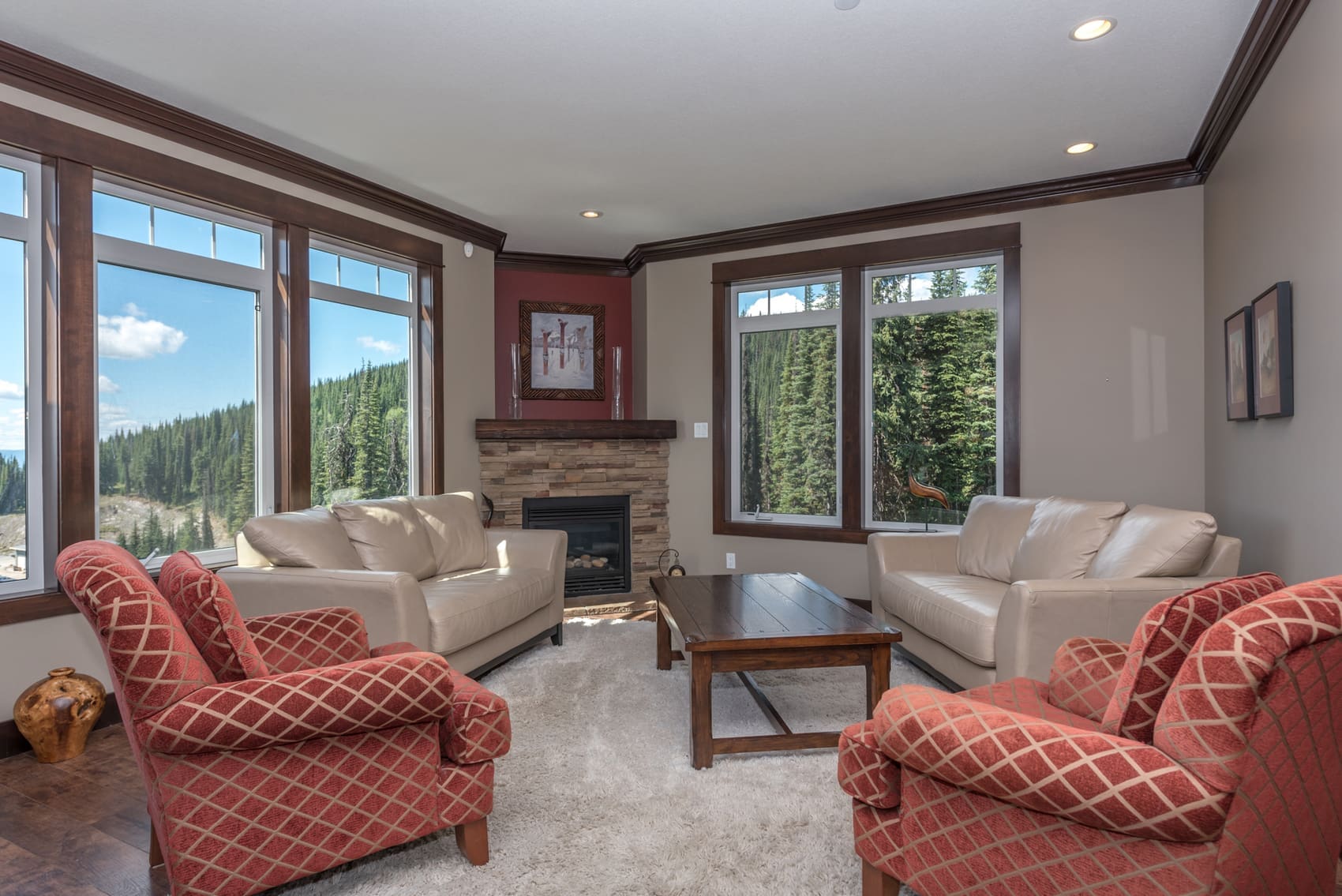 Unique home on the Ridge with 3 levels of living. This is the living room with large bright windows with incredible mountain views, fully stocked kitchen with pantry and modern appliances, private hot tub, laundry, and Weber BBQ on the deck. Enough space and multiple living areas for everyone to spread out.