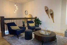 Living Room sitting area next to gas fireplace. Large dining table and modern upgraded kitchen. This home comprises of two living rooms, two kitchens, two private hot tubs, laundry, and a small suite attached for families or friends to spread out.